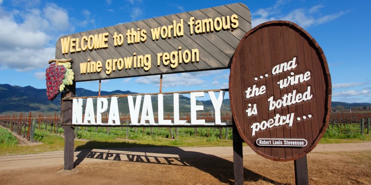 Sign welcoming visitors to Napa Valley, a renowned wine-growing region, with a quote about wine. Sign welcoming visitors to Napa Valley, a renowned wine-growing region, with a quote about wine.